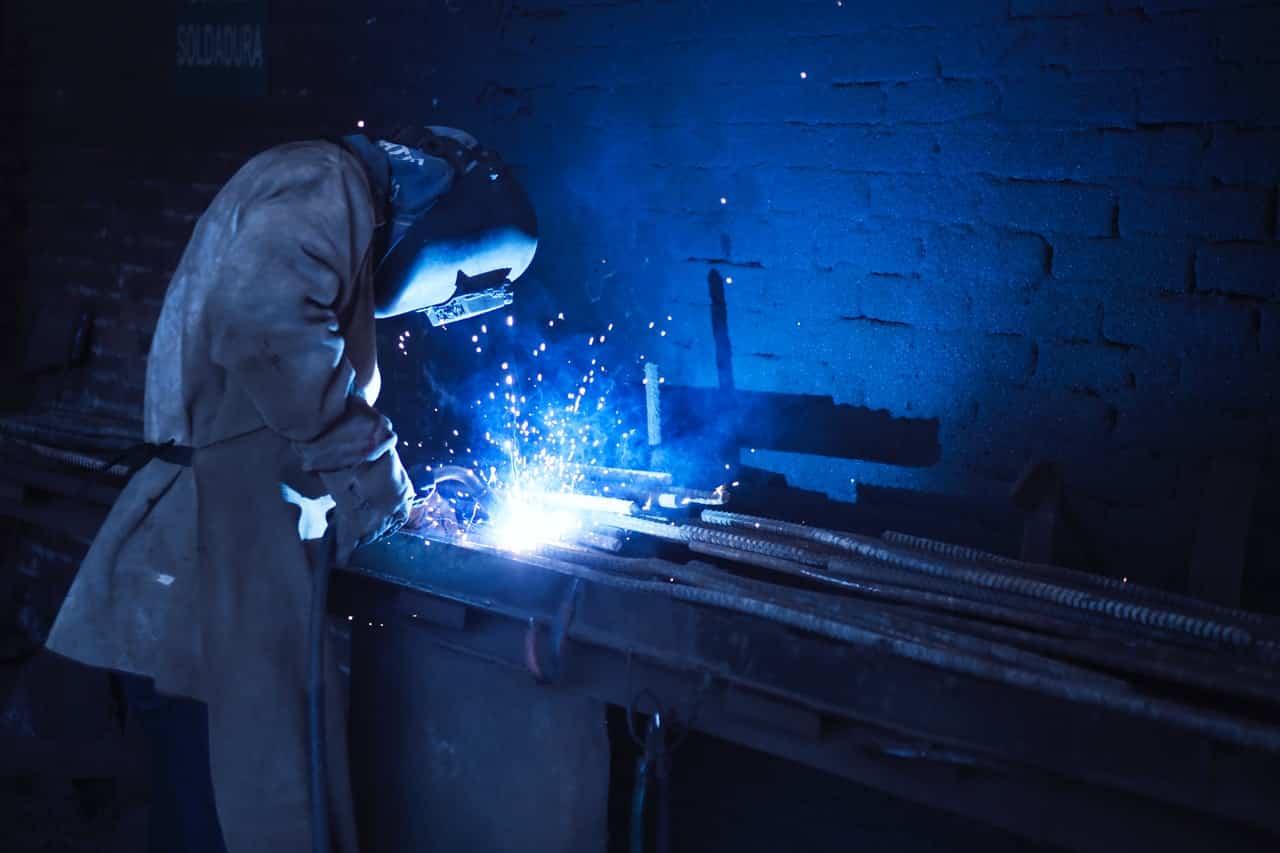 welder working on welding metal