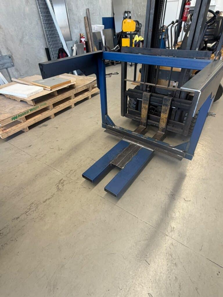 Custom Forklift Attachment Perth – Steel Fabrication Custom forklift attachment Perth – fabricated steel framework mounted on forklift by CSM Fabrication & Welding