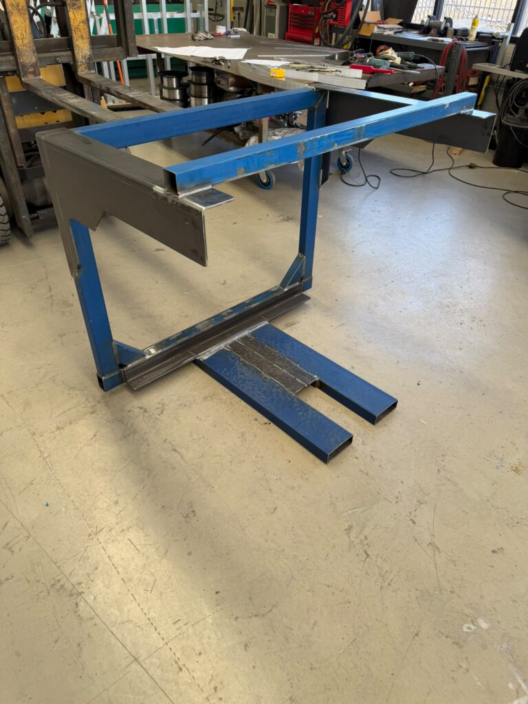 Custom Forklift Attachment Perth – Welded Steel Framework Custom forklift attachment Perth – welded blue steel framework with reinforced supports and fork pockets